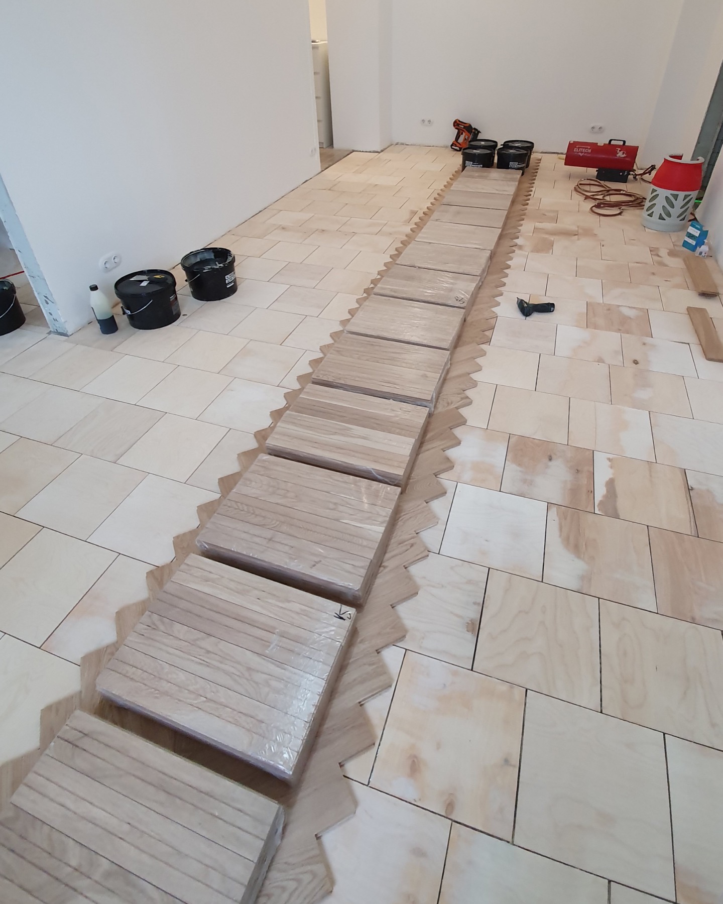 Oak herringbone parquet prepared for layout planning
