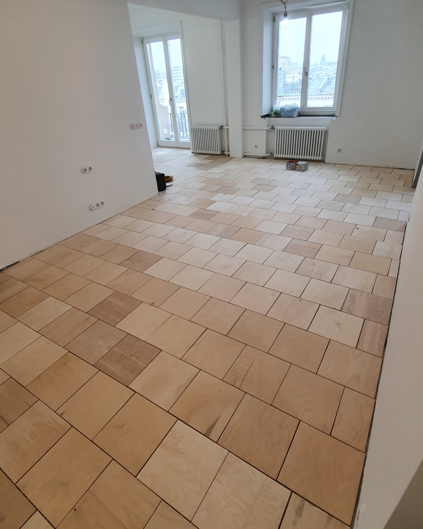 30 by 30 centimeter plywood installed on adhesive
