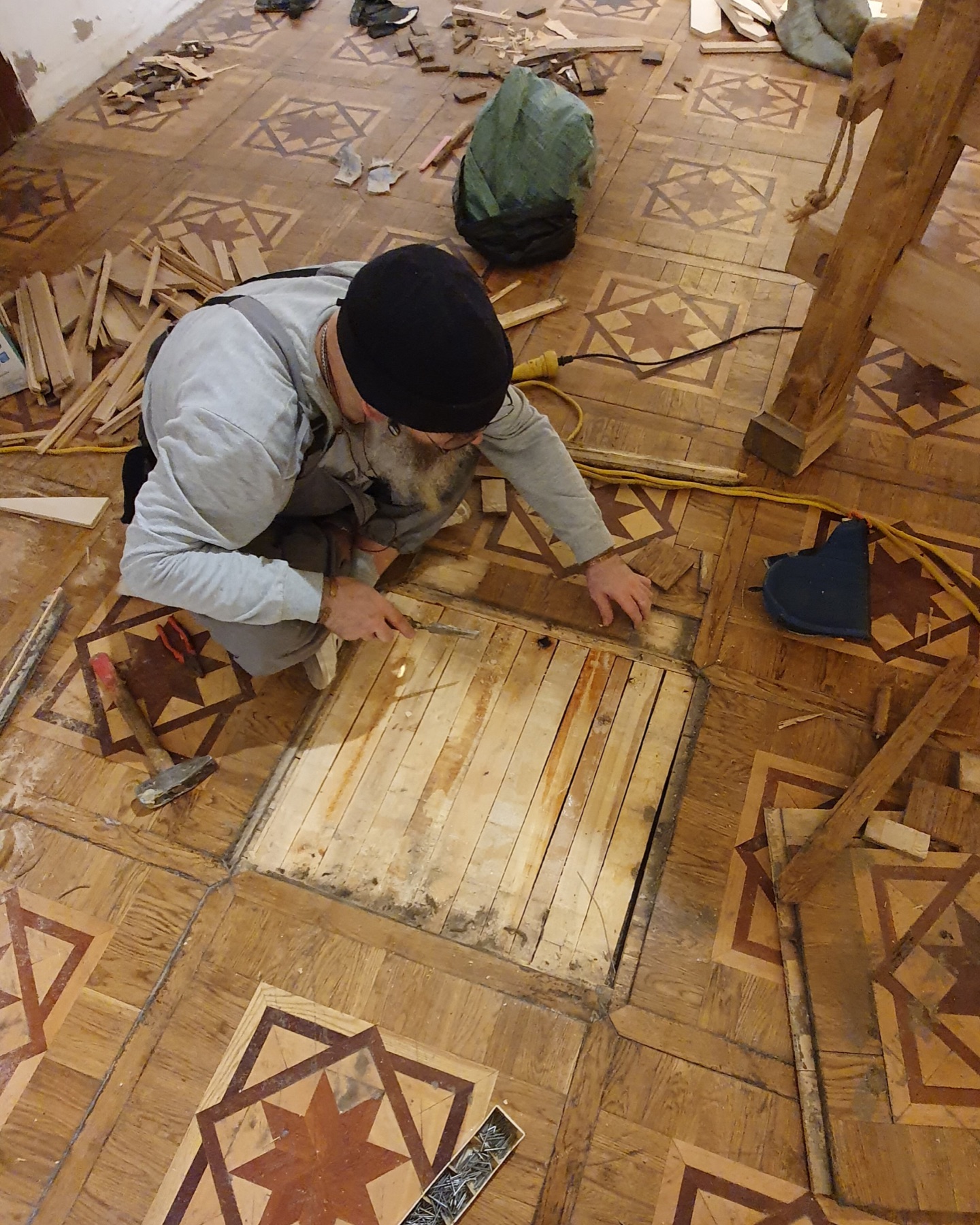 Restoration work on missing pieces of historical mosaic parquet