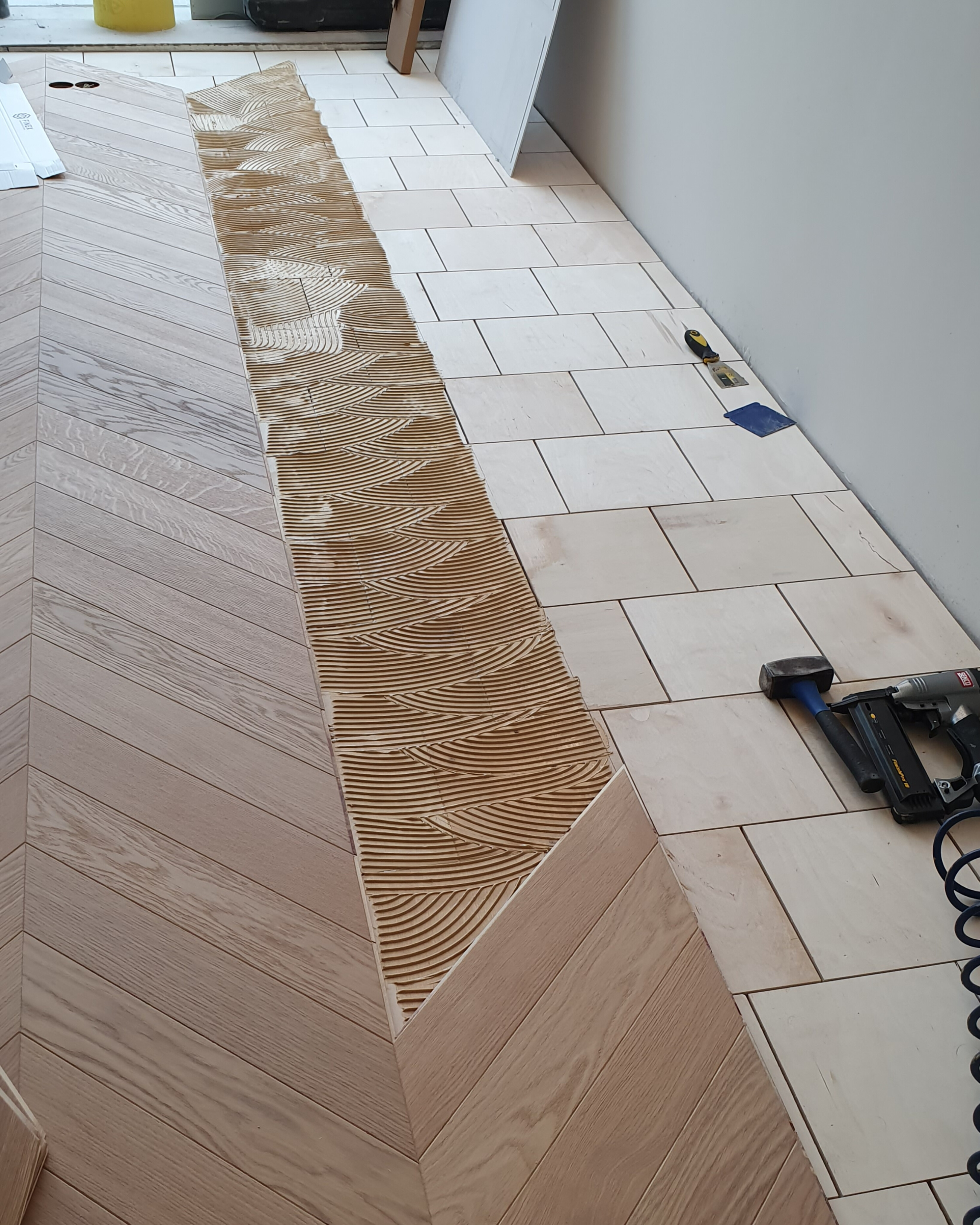 French chevron parquet installation starting over the prepared base
