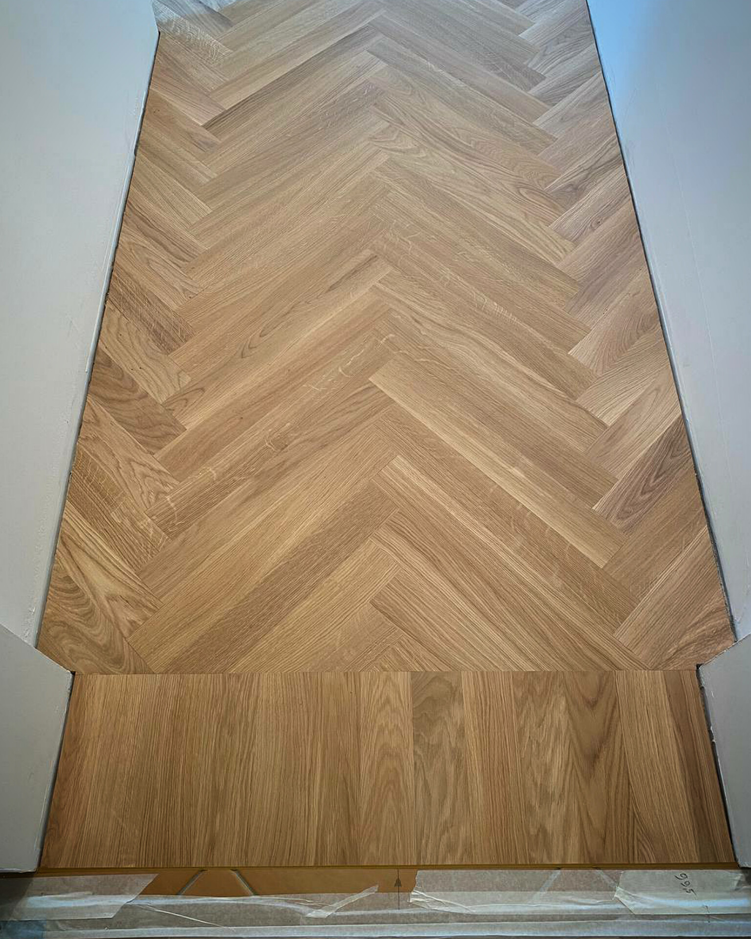Finished English herringbone parquet in the completed hallway area