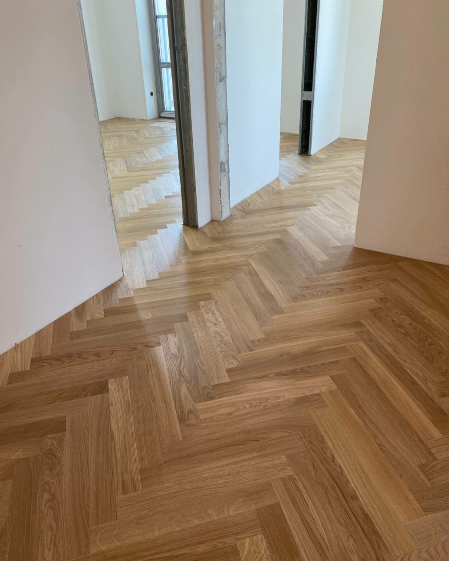 Finished Kahrs parquet board laid in an English herringbone pattern in a modern apartment