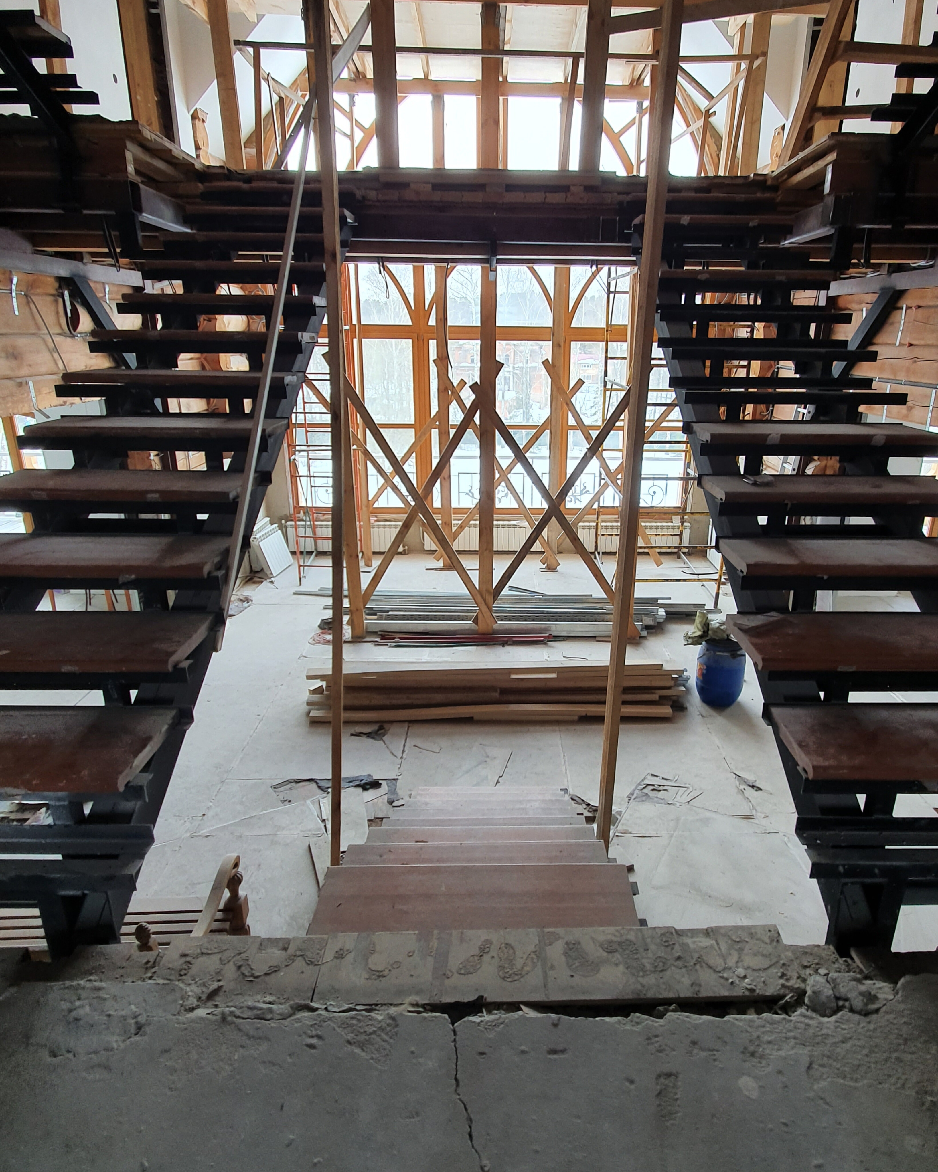 Large private house interior with twin staircases and padauk floors before restoration